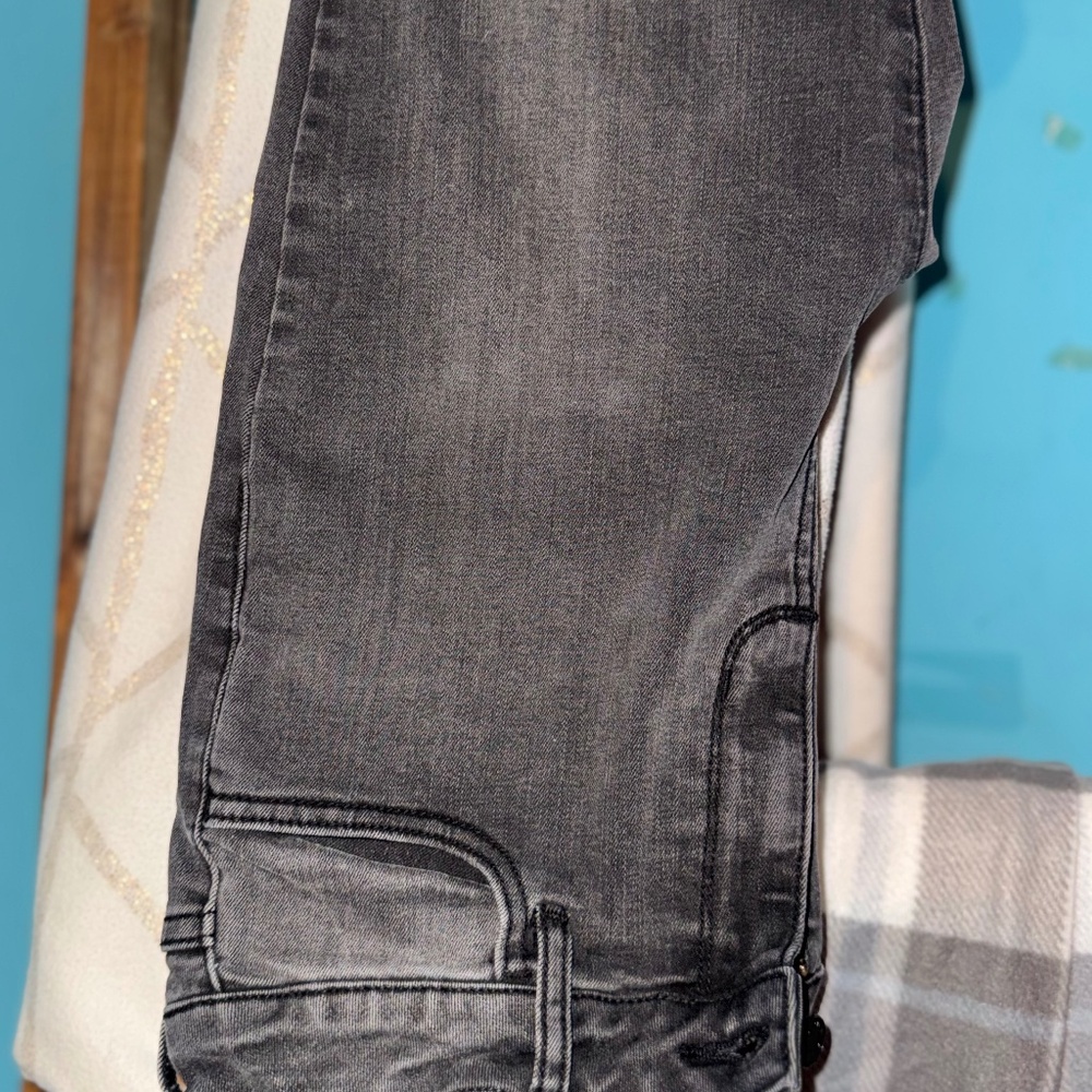 Black straight leg jeans ripped at the bottom